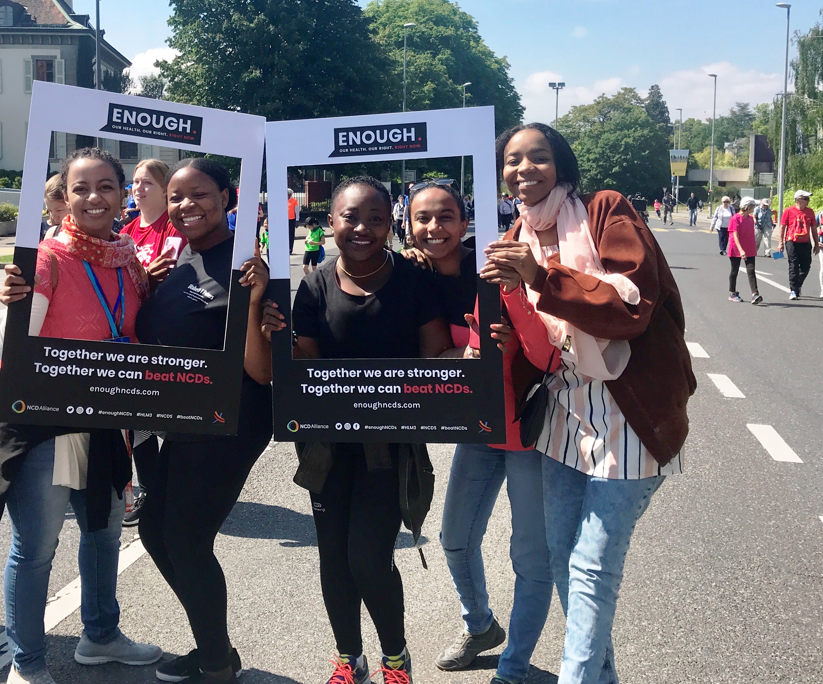 A group of women Walking the Talk, with Enough campaign photo frames, on the streets of Geneva