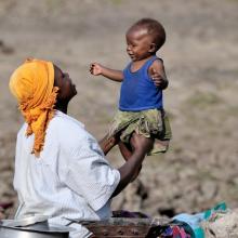 A woman displaced by fighting in the Democratic Republic of Congo in 2008, takes refuge and plays with her child © 2008 Paul Jeffrey, Courtesy of Photoshare