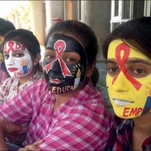 Students recognise International AIDS Candlelight Memorial Day with painted faces at the Centre for Social Work, Panjab University, Chandigarh, India. 