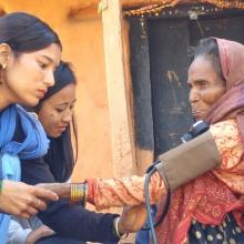 Community health workers check the blood pressure of a woman with breathing difficulties, Achham district, Nepal, Feb 2018